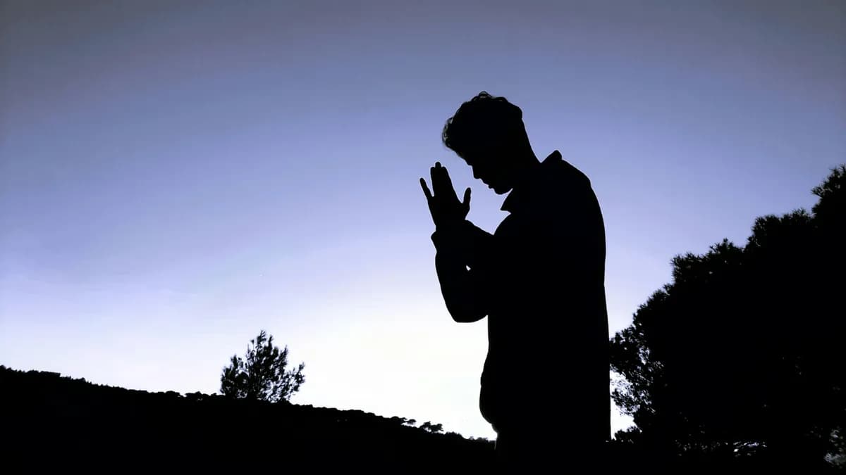 Man praying at dawn